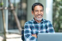 Professional man sitting in front of laptop