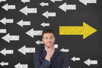 Man standing in front of directional arrows pointing left and right