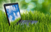 Laptop in a field of green grass